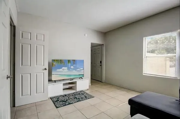 a bedroom with furniture and a flat screen tv