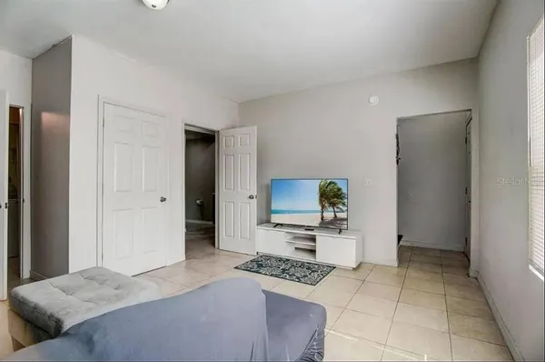 a spacious bedroom with a bed and a dresser