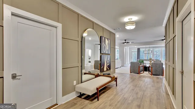 a dining room with furniture a chandelier and wooden floor