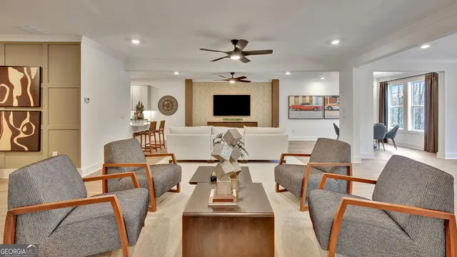 a living room with furniture and wooden floor