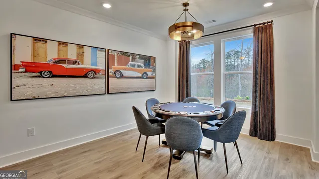 a view of a dining room with furniture wooden floor and chandelier