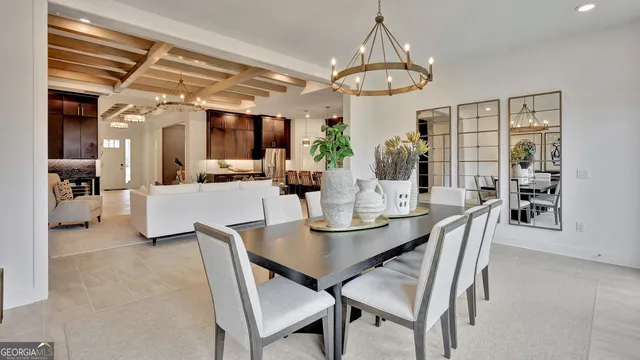 a living room with furniture a chandelier and a table