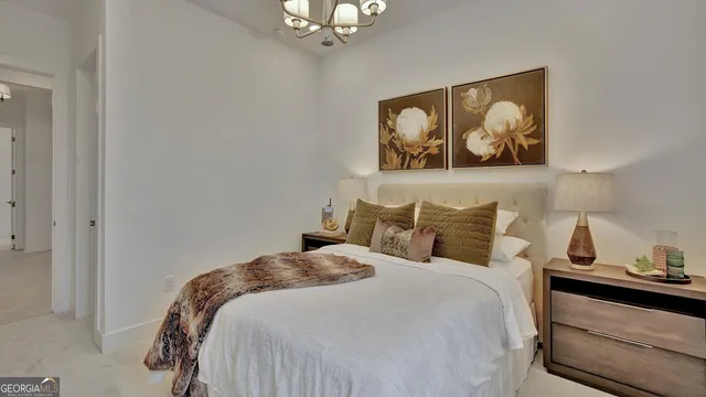 a bedroom with a bed and dresser with mirror