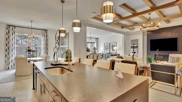 a kitchen with stainless steel appliances granite countertop a sink a stove and a granite counter tops with white cabinets