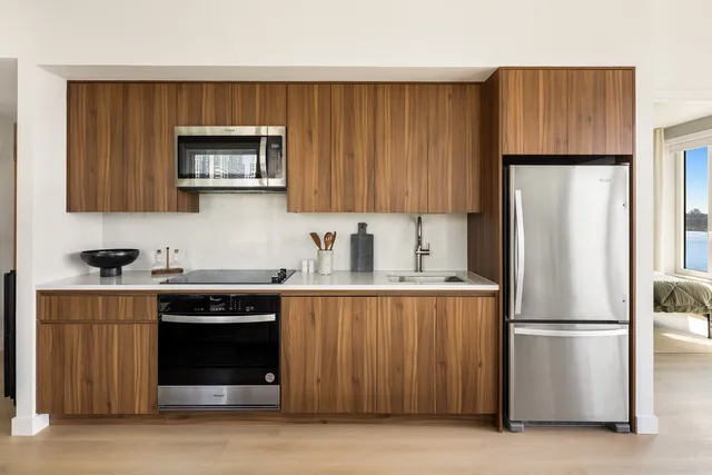 a kitchen with a sink a stove and cabinets