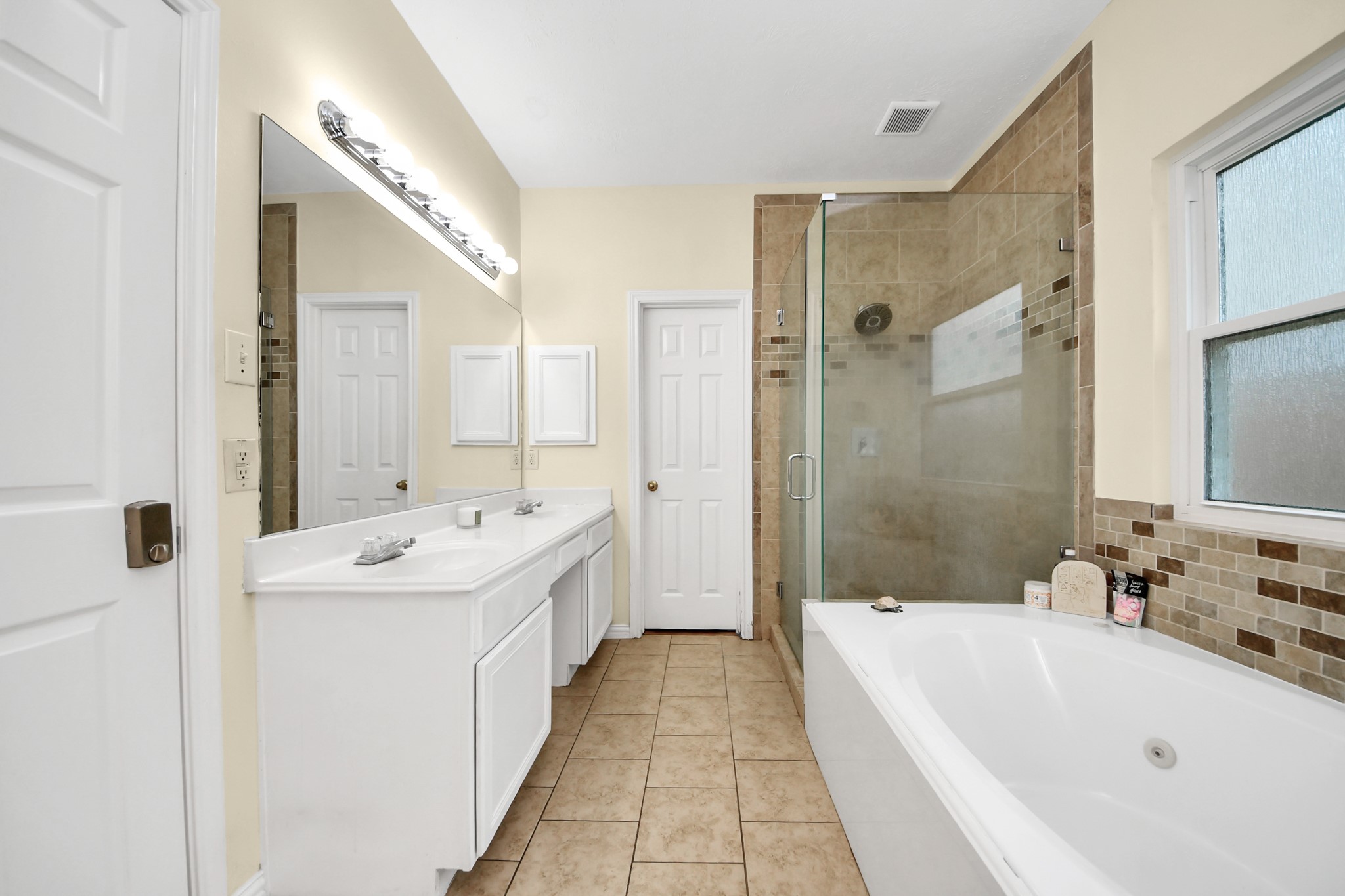 23814 Spring Dane Drive Spring, TX 77373 - Photo 26 of 41 a bathroom with a tub sink and mirror