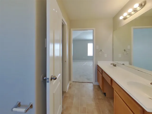 a bathroom with a double vanity sink and mirror