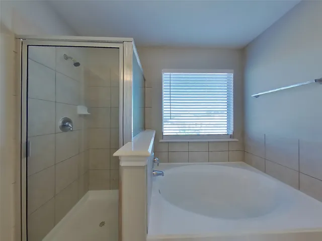 a bathroom with a bathtub and shower