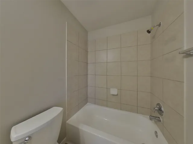 a bathroom with a bathtub and toilet