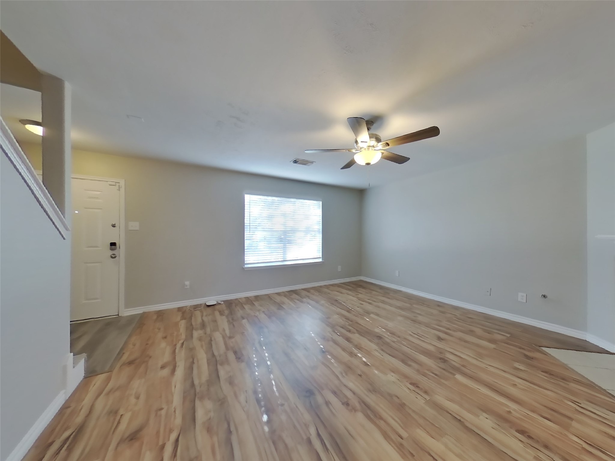 1910 Flycaster Drive Spring, TX 77388 - Photo 2 of 19 a view of an empty room with wooden floor and a window