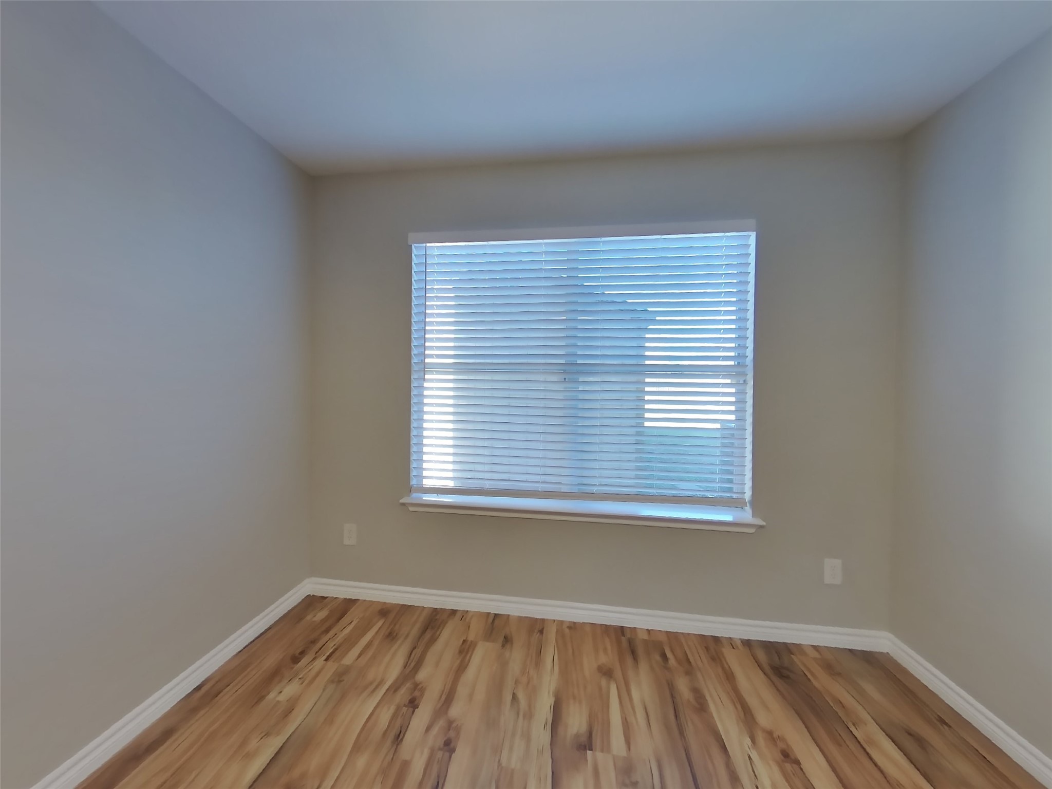 1910 Flycaster Drive Spring, TX 77388 - Photo 5 of 19 an empty room with wooden floor and a window