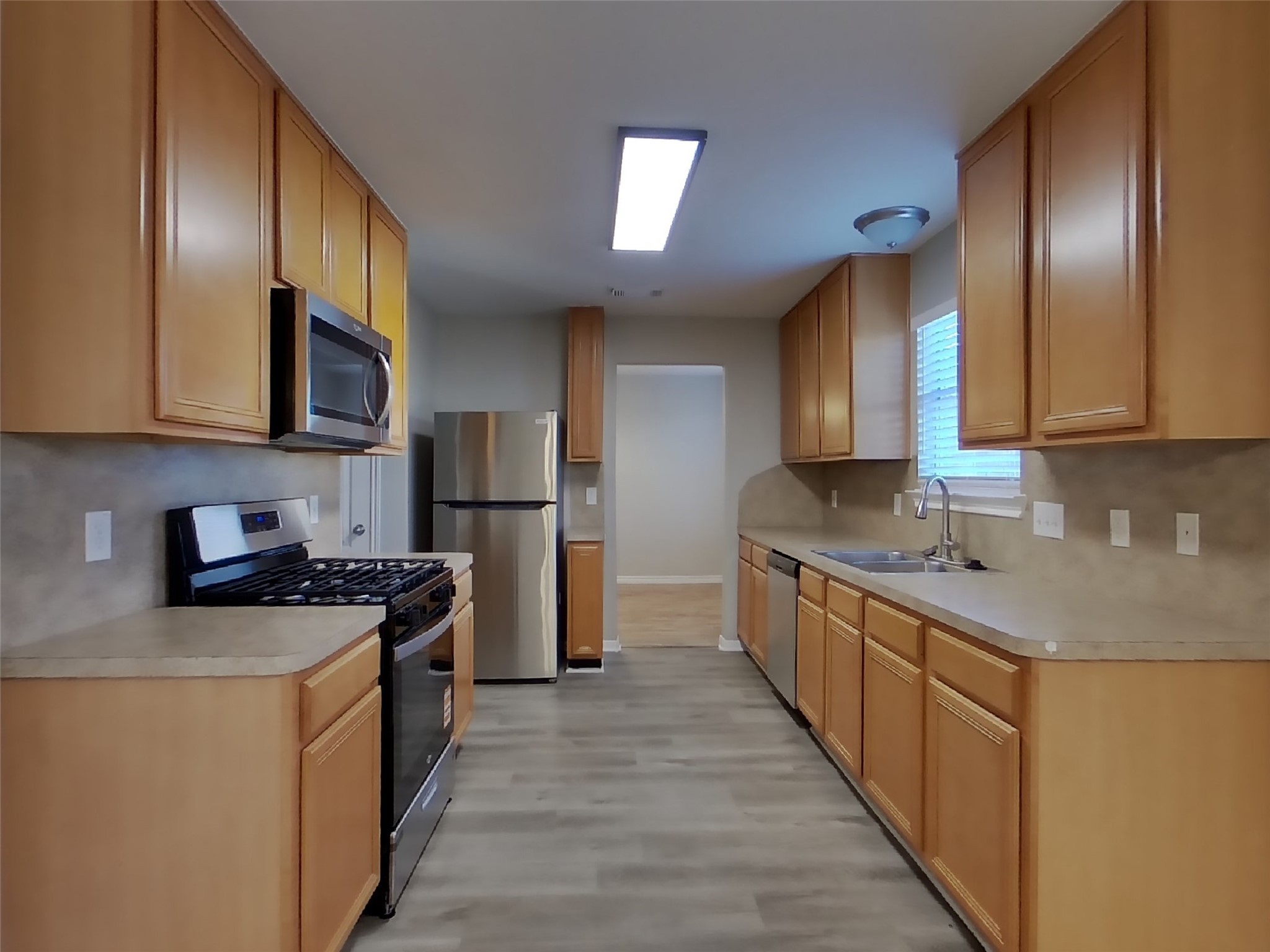 1910 Flycaster Drive Spring, TX 77388 - Photo 7 of 19 a kitchen with stainless steel appliances granite countertop a stove a sink dishwasher a refrigerator and cabinets with wooden floor