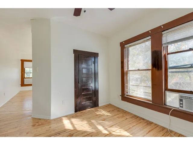 a view of a livingroom with wooden floor and a window