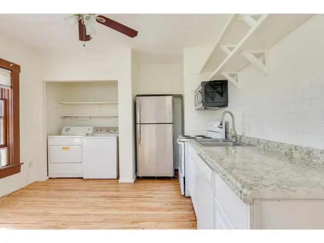a kitchen with a sink a stove and refrigerator