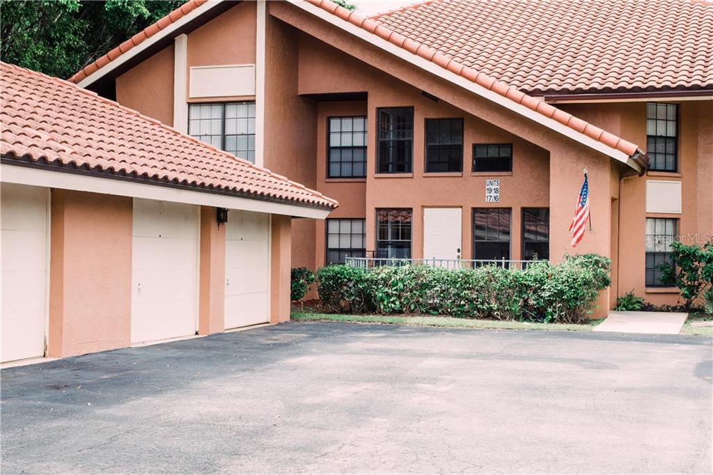 3013 Clark Road, Unit 17 Sarasota, FL 34231 - Photo 1 of 1 a front view of a house with a yard and garage