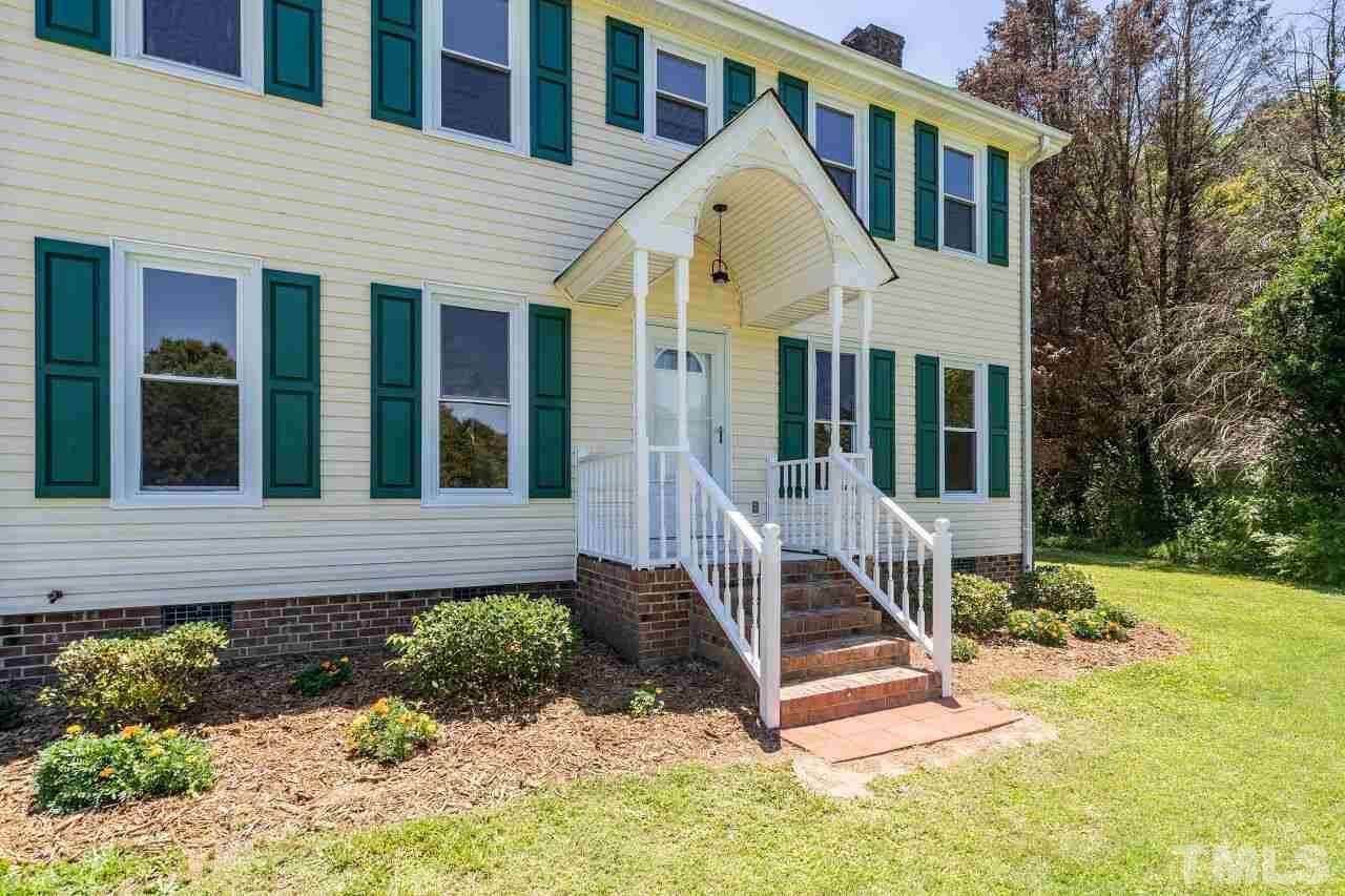 9320 Tallgrass Road Raleigh, NC 27603 - Photo 2 of 28 a view of a house with a yard and large trees