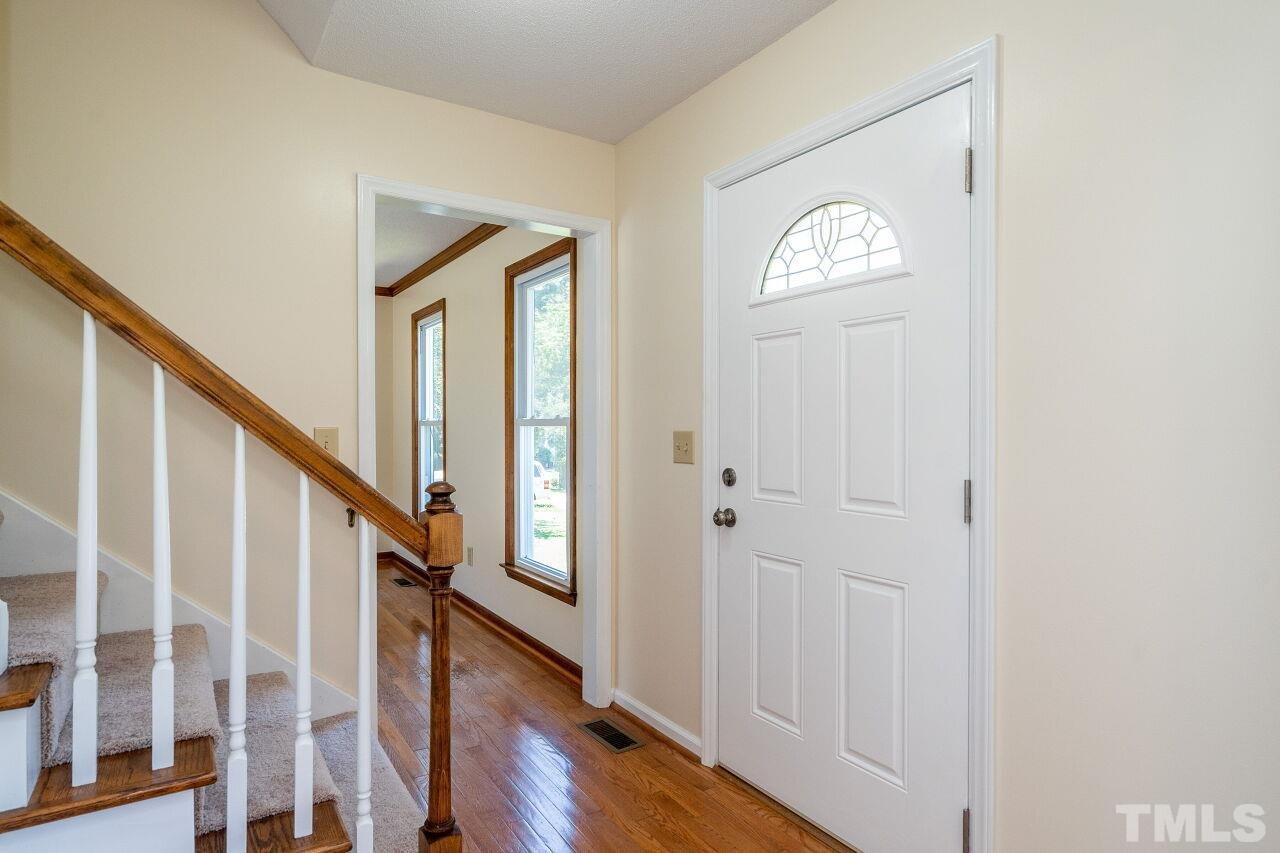 9320 Tallgrass Road Raleigh, NC 27603 - Photo 3 of 28 a view of a hallway with wooden floor and entryway