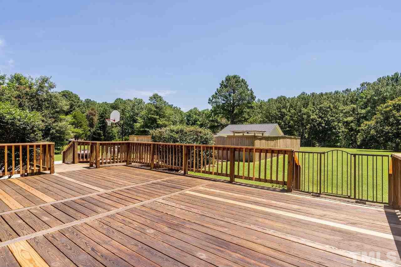 9320 Tallgrass Road Raleigh, NC 27603 - Photo 22 of 28 a view of a balcony with wooden floor and fence