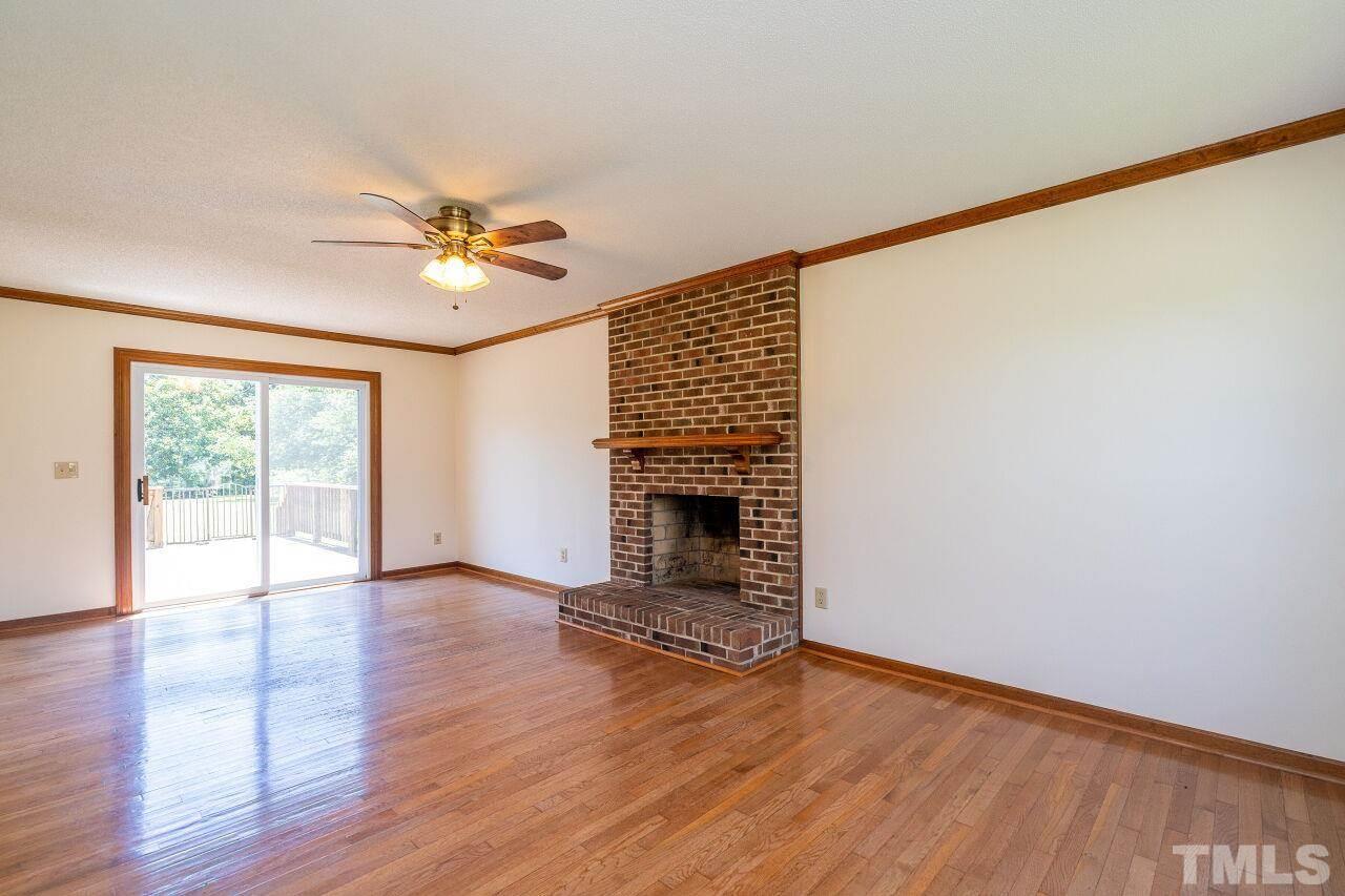 9320 Tallgrass Road Raleigh, NC 27603 - Photo 5 of 28 wooden floor in an empty room with a window