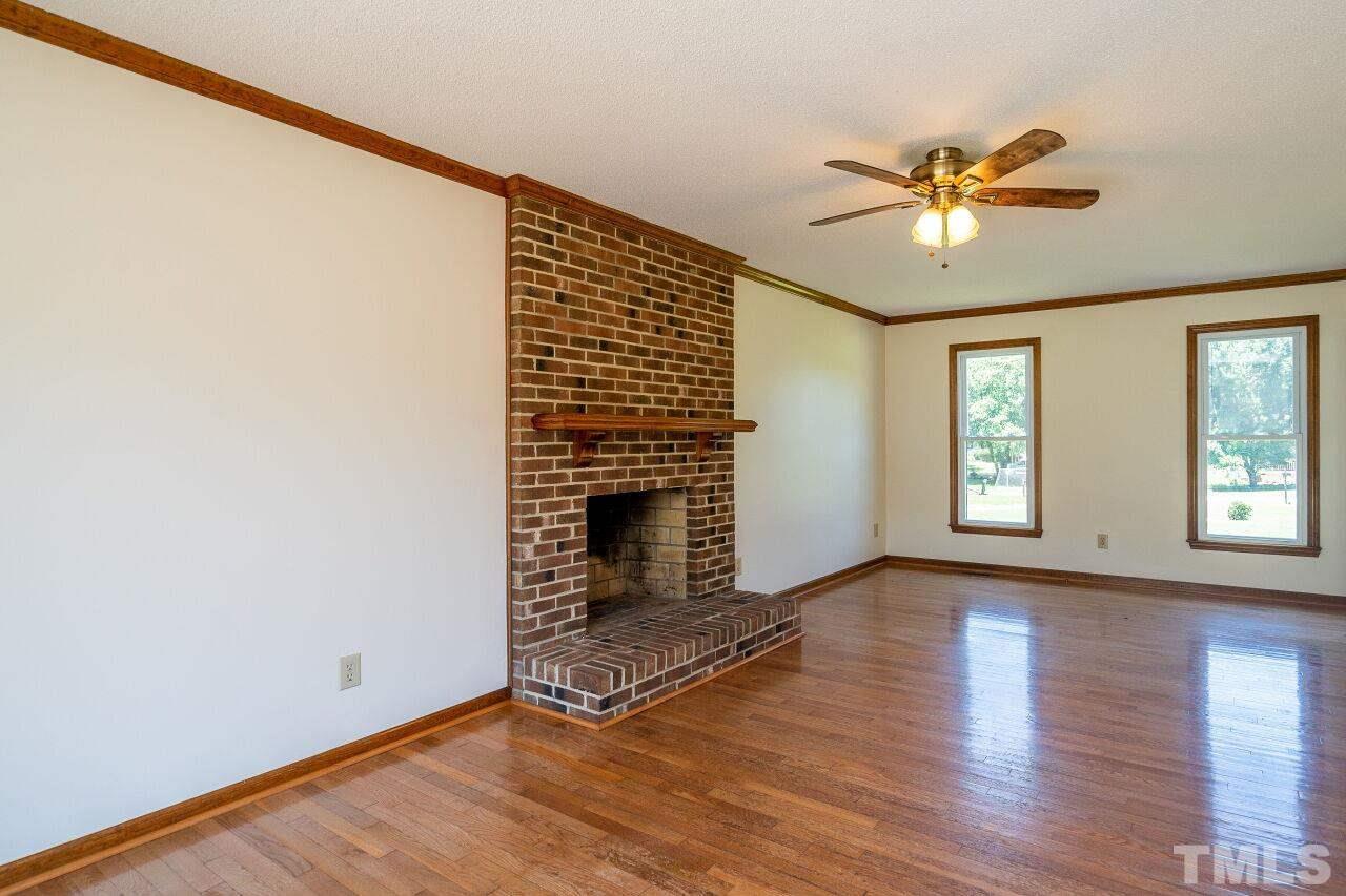 9320 Tallgrass Road Raleigh, NC 27603 - Photo 6 of 28 a view of an empty room with wooden floor and a window