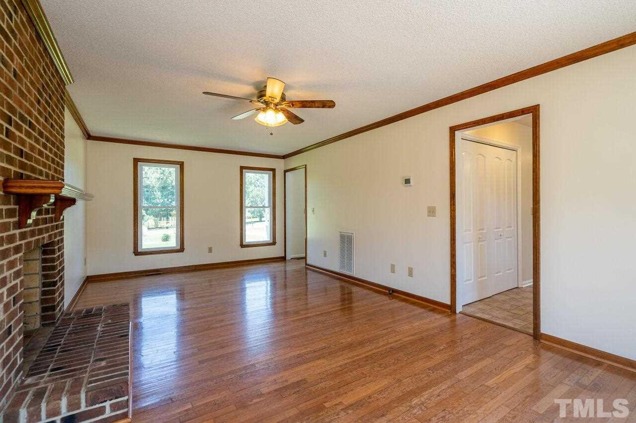 9320 Tallgrass Road Raleigh, NC 27603 - Photo 7 of 28 wooden floor in an empty room with a window