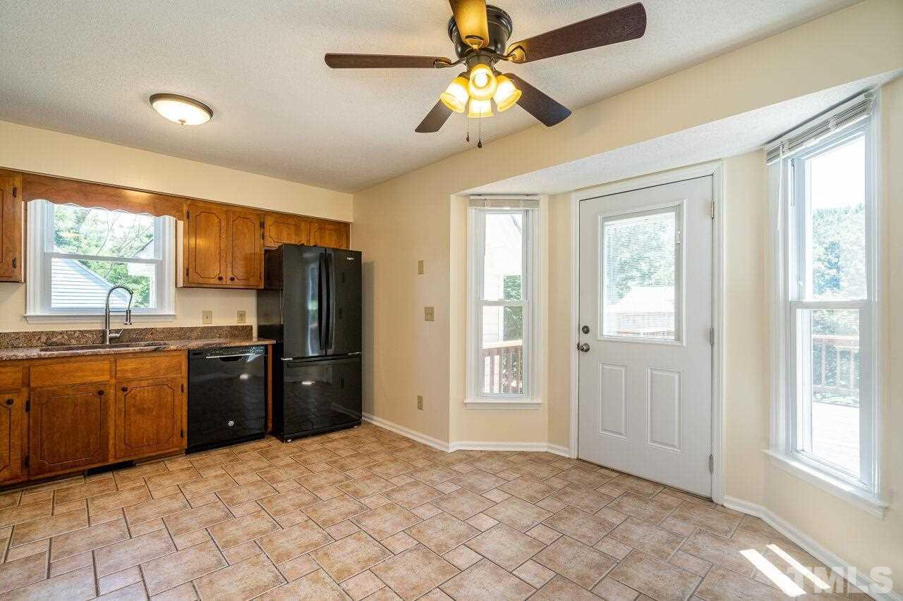 9320 Tallgrass Road Raleigh, NC 27603 - Photo 8 of 28 a kitchen with stainless steel appliances granite countertop a refrigerator and a sink