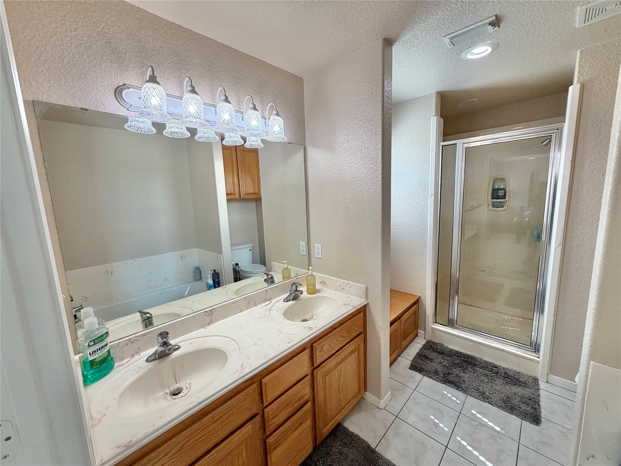 15903 County Road 621 Angleton, TX 77515 - Photo 23 of 33 a bathroom with a double vanity sink mirror and shower