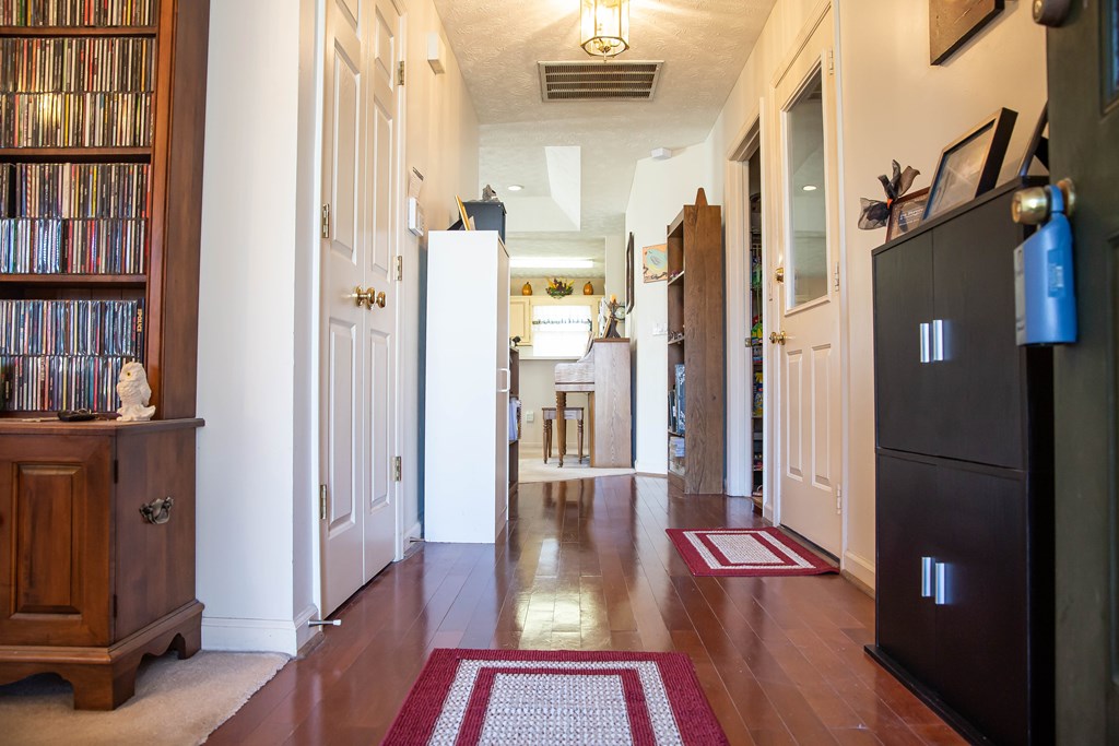 4383 Reesewood Court Columbus, GA 31907 - Photo 3 of 32 a view of a hallway with wooden floor and livingroom with furniture