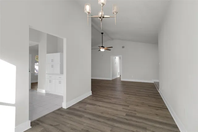 a view of a hallway with wooden floor