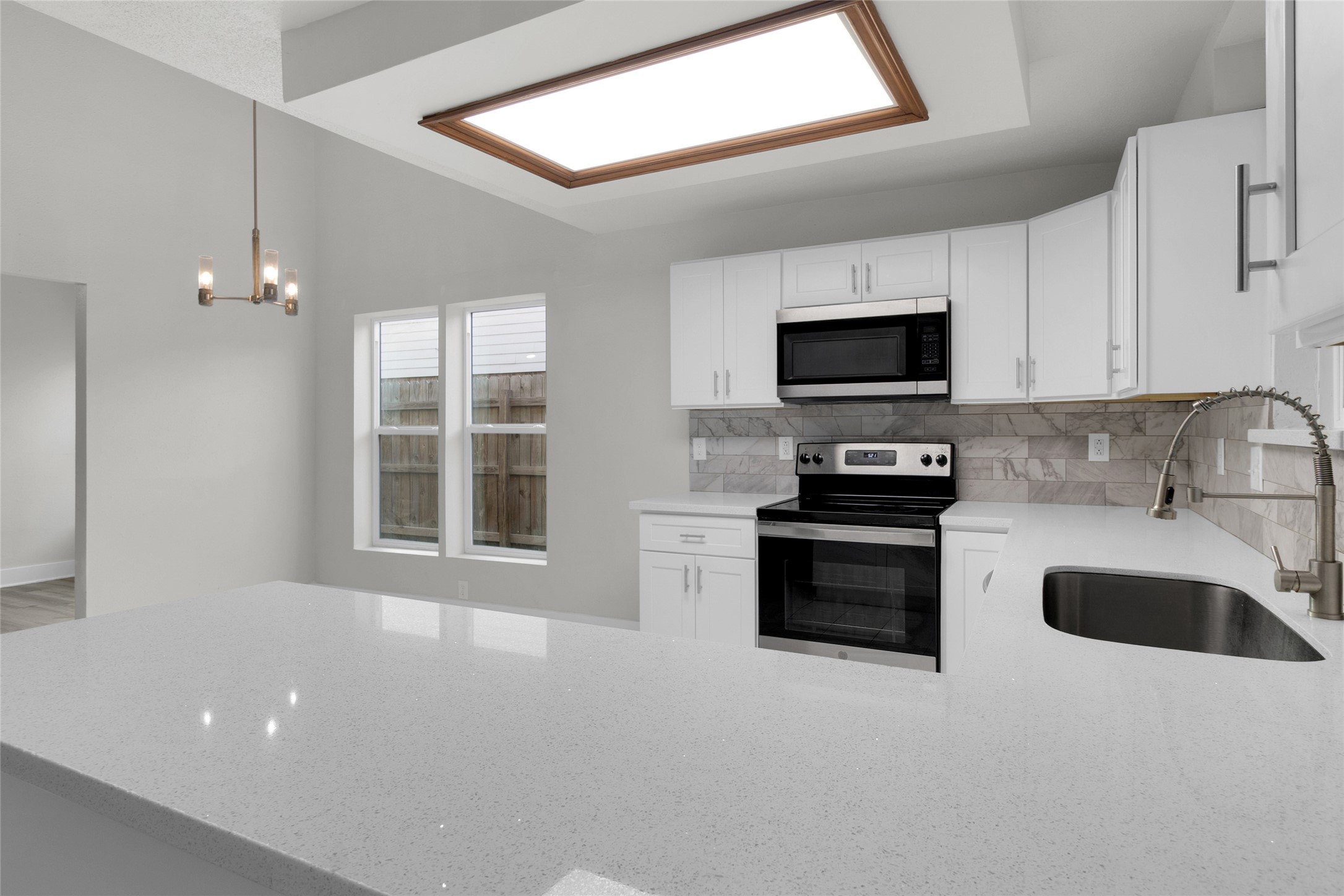 23910 Spring Briar Lane Spring, TX 77373 - Photo 14 of 38 a kitchen with granite countertop a stove and a microwave