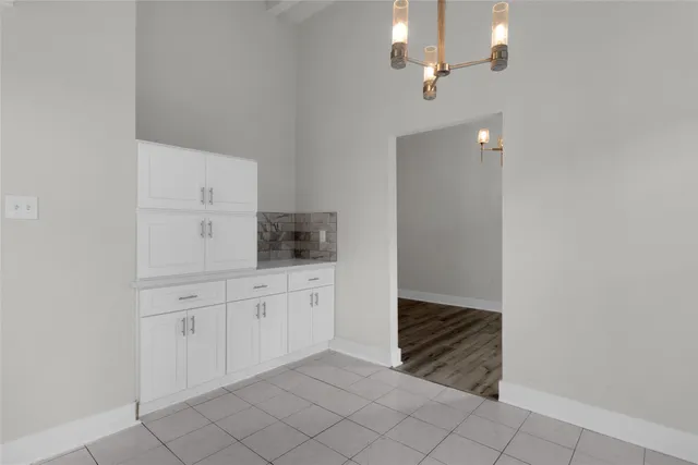a kitchen with white cabinets