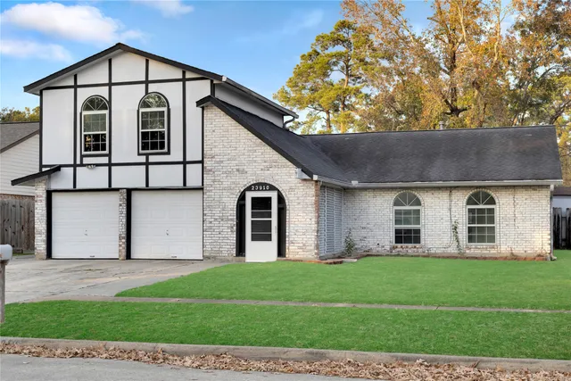 a front view of a house with a yard and garage