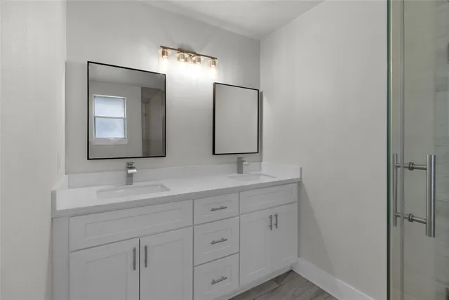 a bathroom with 2 sink and a mirror