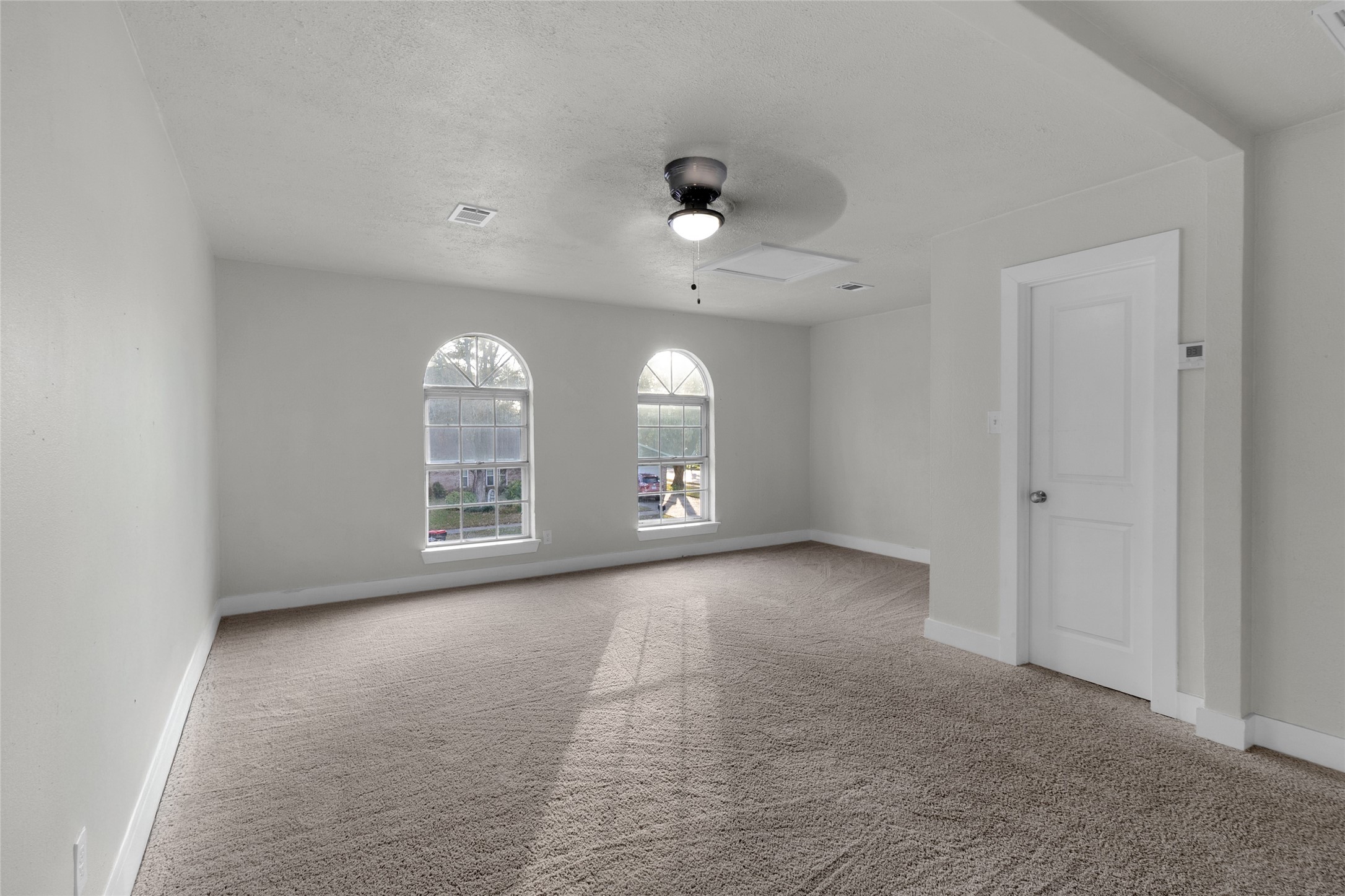 23910 Spring Briar Lane Spring, TX 77373 - Photo 29 of 38 an empty room with chandelier fan and windows