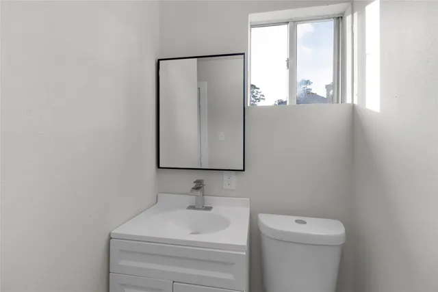 a view of an empty room with floor to ceiling windows with wooden fence