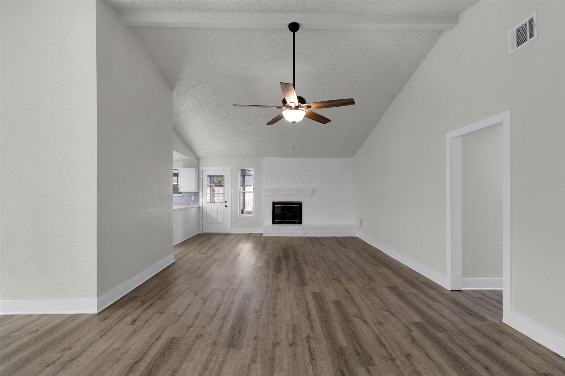 23910 Spring Briar Lane Spring, TX 77373 - Photo 5 of 38 an empty room with wooden floor chandelier fan and windows