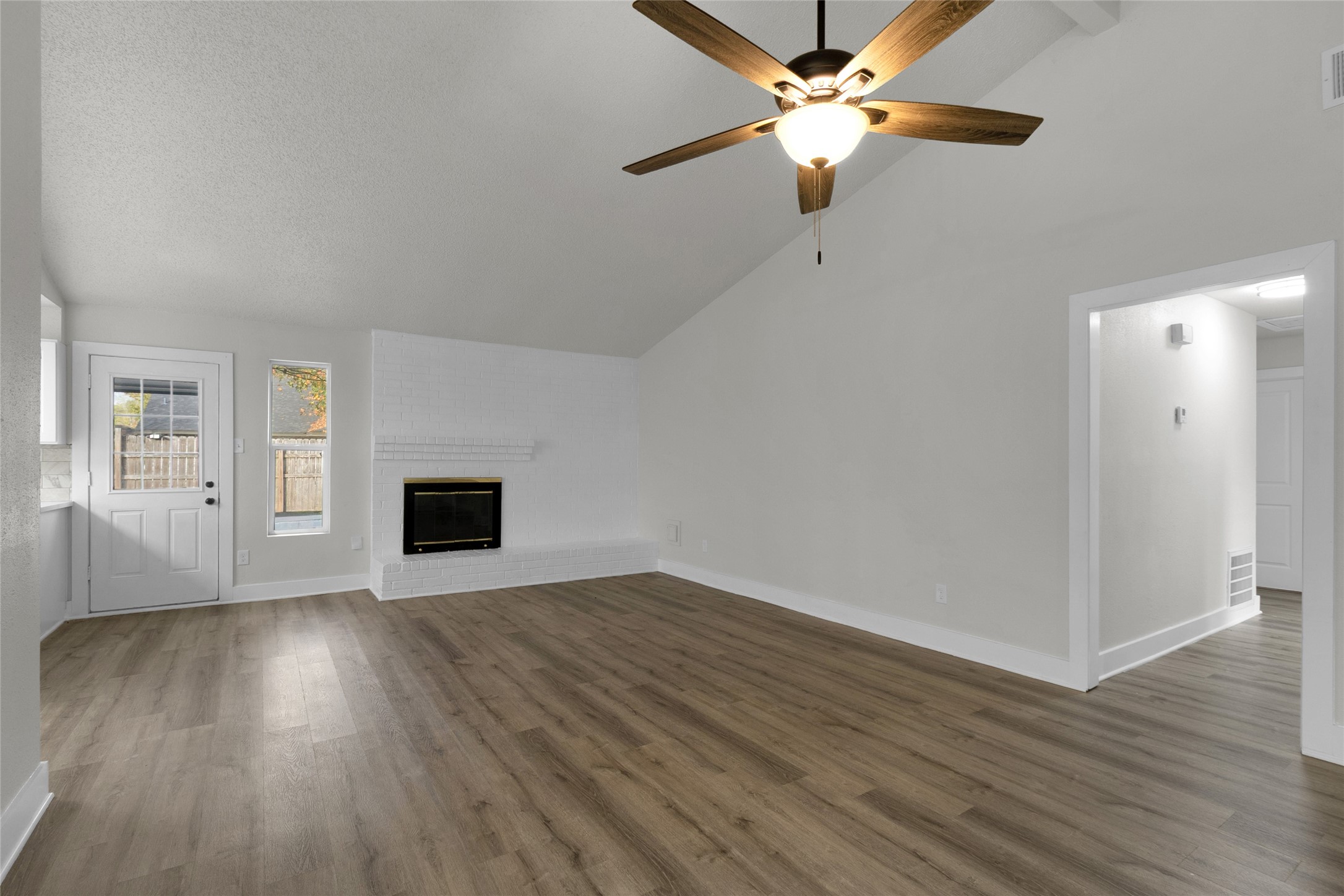 23910 Spring Briar Lane Spring, TX 77373 - Photo 7 of 38 a view of an empty room with wooden floor and a ceiling fan