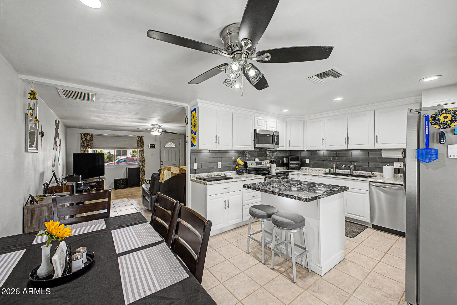 14002 North 37th Place Phoenix, AZ 85032 - Photo 13 of 33 a kitchen with stainless steel appliances kitchen island granite countertop a sink and cabinets