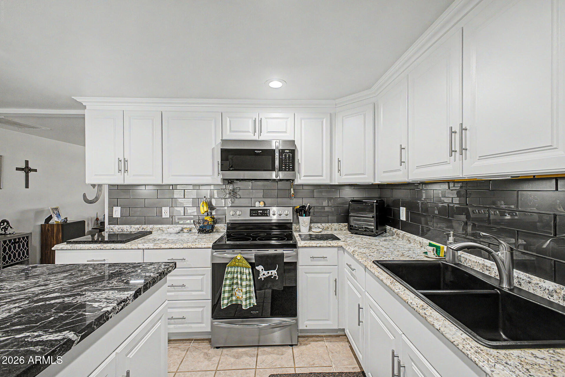 14002 North 37th Place Phoenix, AZ 85032 - Photo 14 of 33 a kitchen with granite countertop a sink a stove and cabinets