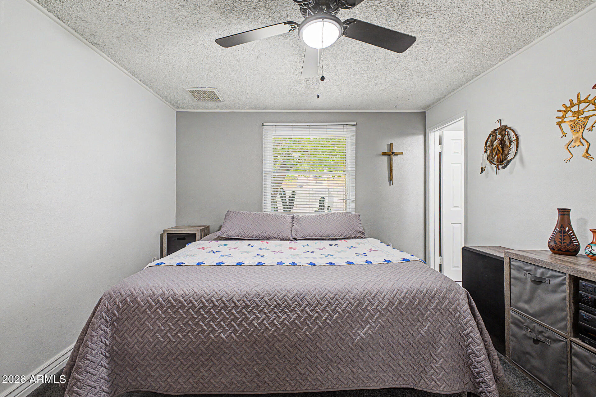 14002 North 37th Place Phoenix, AZ 85032 - Photo 17 of 33 a bedroom with a bed and a chandelier