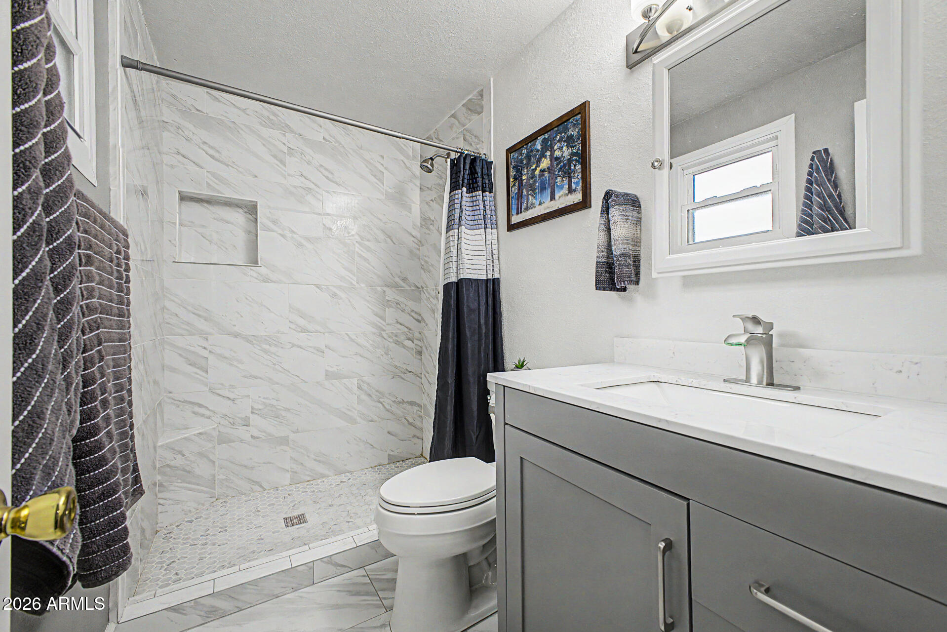 14002 North 37th Place Phoenix, AZ 85032 - Photo 19 of 33 a bathroom with a sink a toilet and shower
