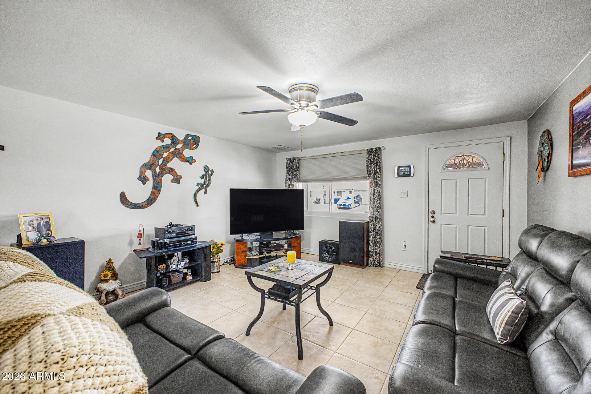 14002 North 37th Place Phoenix, AZ 85032 - Photo 10 of 33 a living room with furniture a flat screen tv and a window