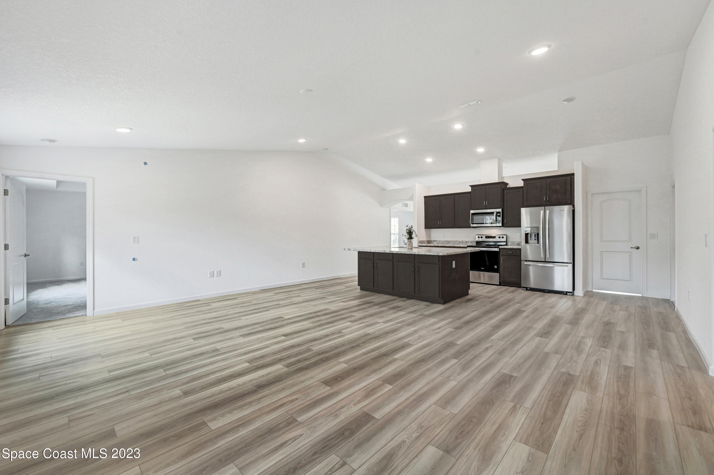 1018 Savery Road Palm Bay, FL 32908 - Photo 29 of 41 Family Room and Kitchen