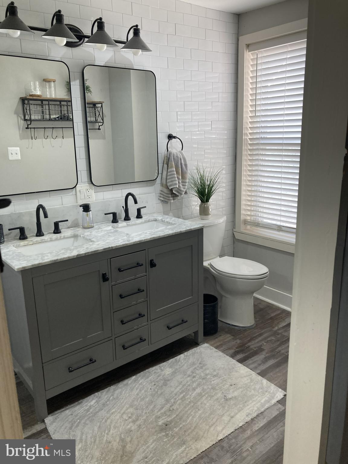 1304 Marlborough Street Philadelphia, PA 19125 - Photo 17 of 19 a bathroom with a toilet sink and mirror