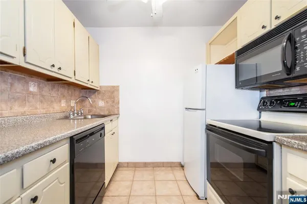 a kitchen with granite countertop a stove and a sink