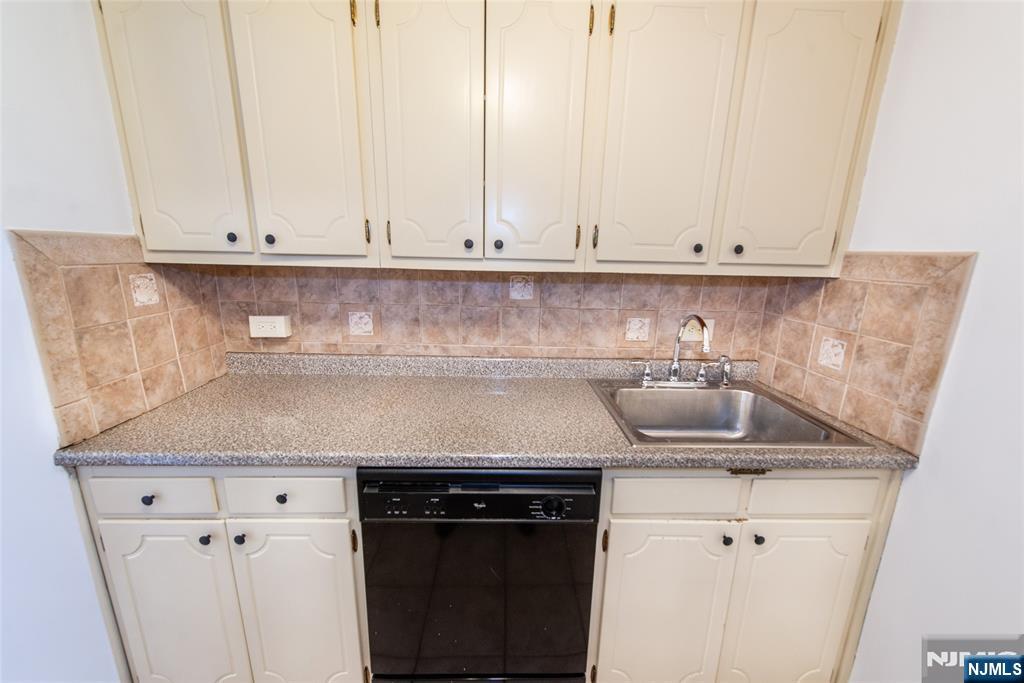 265 Main Street, Unit 503 Ridgefield Park, NJ 07660 - Photo 14 of 23 a kitchen with a sink and cabinets