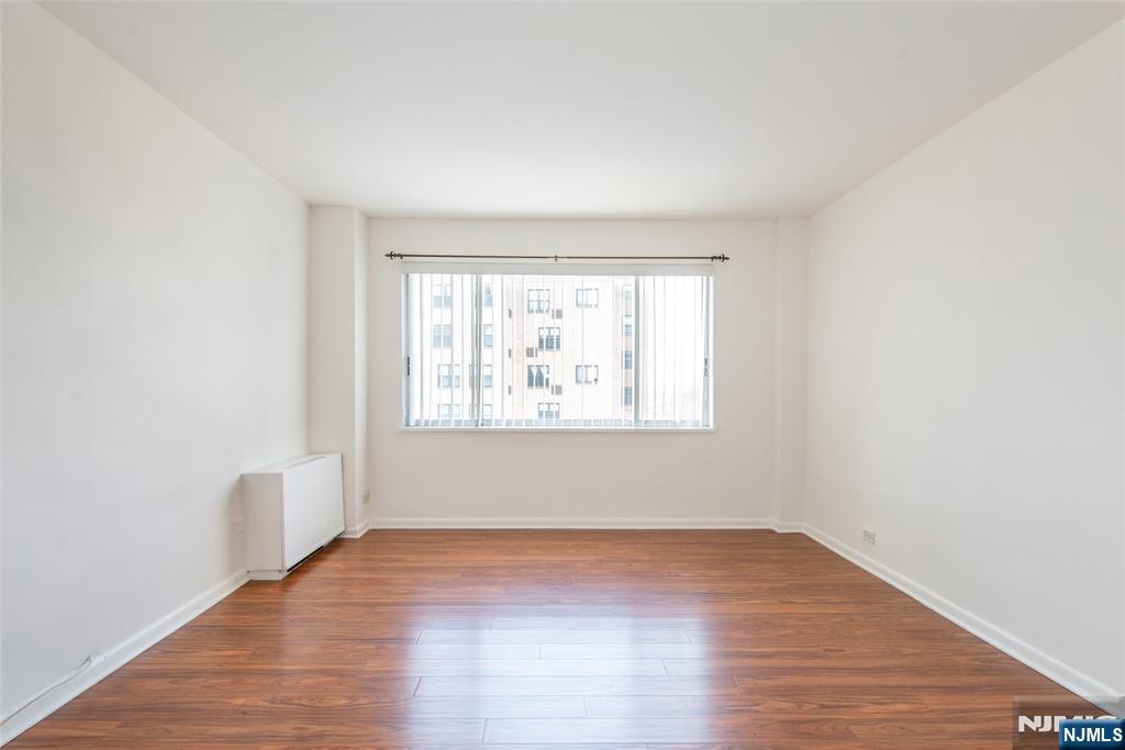 265 Main Street, Unit 503 Ridgefield Park, NJ 07660 - Photo 15 of 23 an empty room with wooden floor and windows