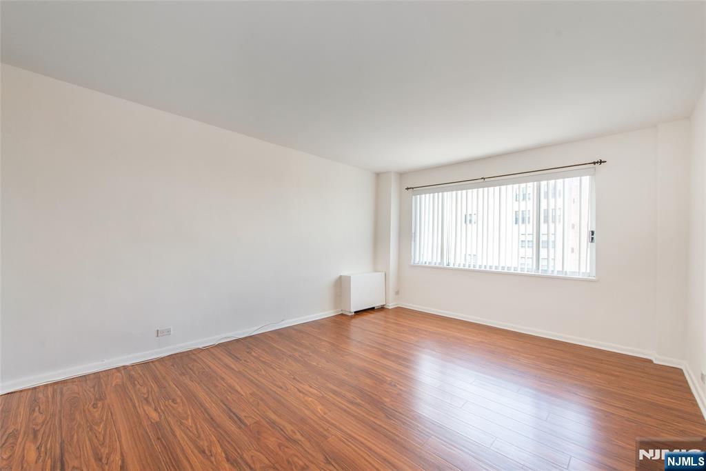 265 Main Street, Unit 503 Ridgefield Park, NJ 07660 - Photo 16 of 23 a view of an empty room with wooden floor and a window