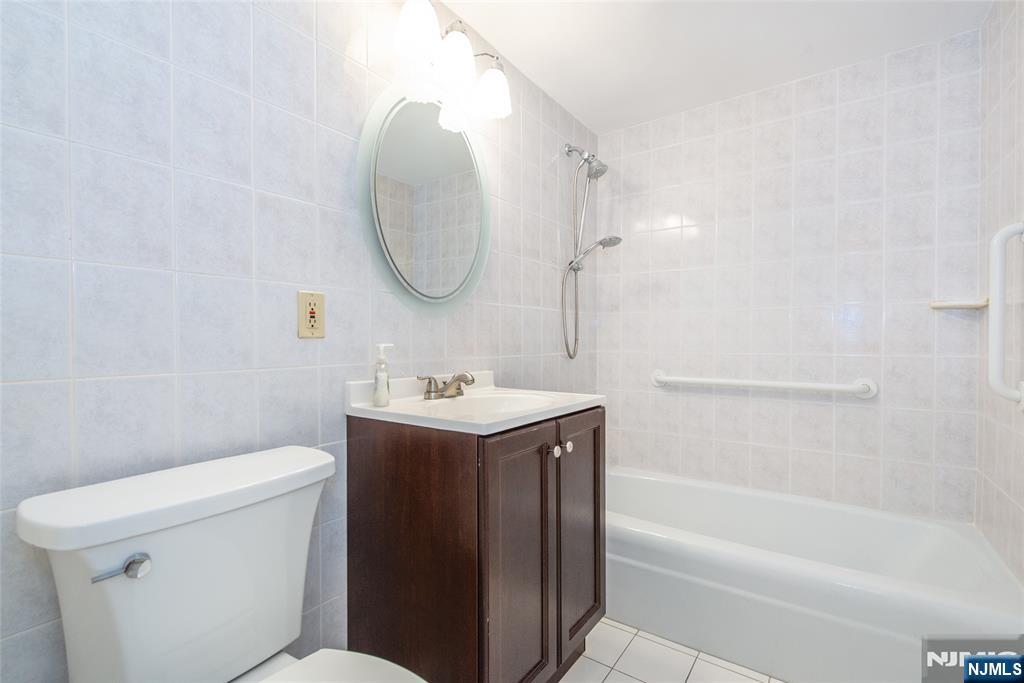 265 Main Street, Unit 503 Ridgefield Park, NJ 07660 - Photo 18 of 23 a bathroom with a sink a toilet and a bathtub
