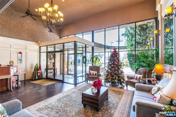 a living room with patio furniture and a large window